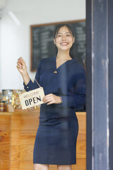 Wall Mural - Portrait of asian woman sme business coffee shop owner smiling beautifully and opening a coffee shop that is her own business, Small business concept.