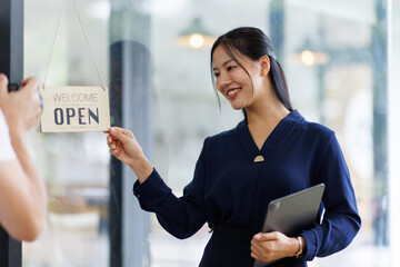 Wall Mural - Portrait of asian woman sme business coffee shop owner smiling beautifully and opening a coffee shop that is her own business, Small business concept.