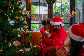 Wall Mural - Family decorate Christmas tree at home.