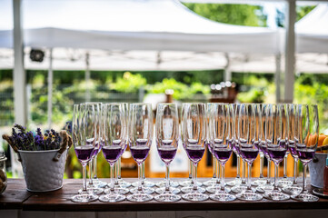 multiple glass of purple wine on the bar in the garden