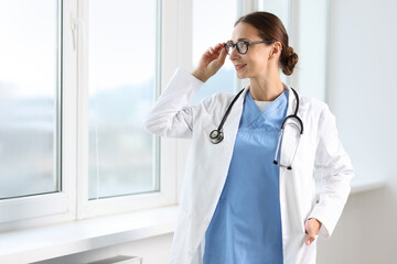 Wall Mural - Nurse with stethoscope near window in clinic