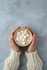 Wall Mural - woman holding a cup of coffee with marshmallows, top view. Selective focus