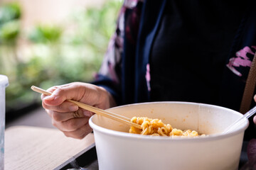 Chopstick holding some noodle