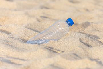 Plastic bottle on the beach left by tourist