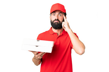 Wall Mural - Pizza delivery man with work uniform picking up pizza boxes over isolated chroma key background thinking an idea