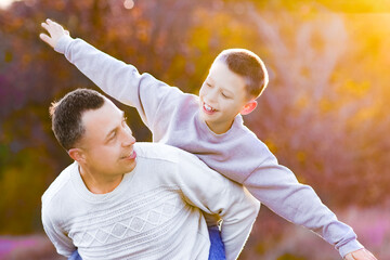 Wall Mural - father walks with child emotions concept family