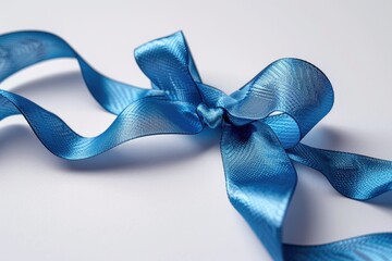 Aufkleber - A close-up of a blue ribbon on a white surface