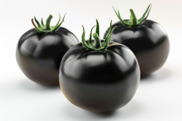 Three ripe black tomatoes stacked on top of each other