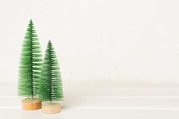 Small christmas trees on wooden table