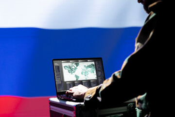 Poster - Soviet operative in Russian army conducts tactical reconnaissance, utilizing laptop for data analysis and mission planning. FSB Kremlin regime military using aerial map on screen, pinpointing targets