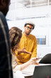 © DC Studio - Realtor financier gives legal assistance to business clients regarding real estate investment plans, reviewing blueprints of a high class office space building. Rental agreement meeting.