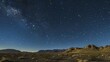 © Galib - A starry night sky over a desert landscape.
