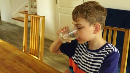 Wall Mural - Kid drinks water at the kitchen