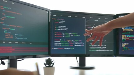 Slow motion back end software developer engineer for computer programming working together on debugging writing computing code, solving complex algorithms display on monitor in office. Burgeoning
