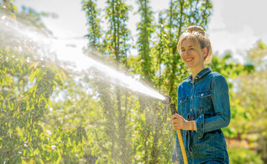 woman watering plants in the garden