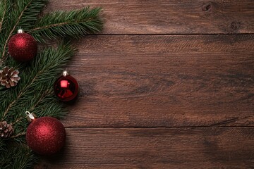 Poster - Christmas ornaments and pine branches on wooden background