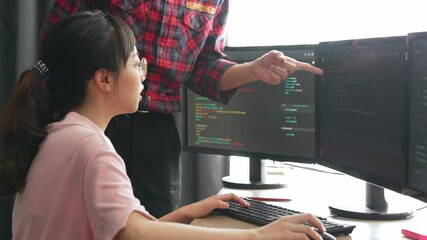 Slow motion back end or software developer manager supervising his team on new application program development on debugging and solving complex code algorithms on monitor. Burgeoning