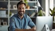 © Qstock - Professional Smiling Man Working on Computer in Modern Office Environment