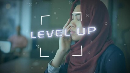 Poster - Animation of level up text over biracial woman in hijab using smartphone