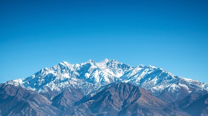 Wall Mural - A snow-capped mountain range with a clear blue sky.