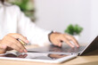 © Smile Studio AP - Business woman working on laptop computer with digital tablet on office table. searching the information, freelance lifestyle. Female freelancer busy working on laptop, surfing the internet,