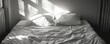 © BonzEarthsnapper - An unmade bed with a single pillow left undisturbed, loss, the absence of companionship
