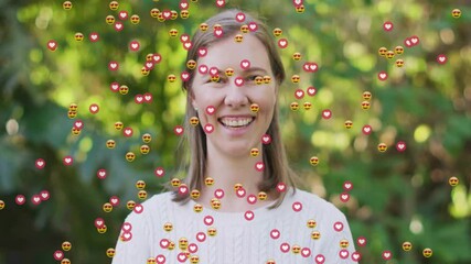 Sticker - Animation of media icons over caucasian woman smiling in garden