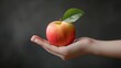 © cloud7days - Hand holding an apple, focusing on its smooth surface and vibrant color.