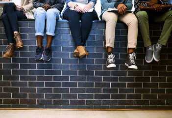 Poster - Shoes, students and group on wall at college with studying, learning and together for development. People, feet and friends on break in hallway at campus, university and scholarship with education