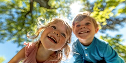 Canvas Print - Two children laughing and looking up at the camera. AI.