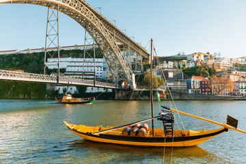 Wall Mural - Porto, Portugal. Bridge Ponte Luis I over Douro river. Old traditional boats on the river.