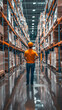 © Marta P. (Milacroft) - Warehouse manager standing in a large distribution center with shelves full of goods