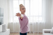 © Николай Амосеев - Practicing yoga, a woman is in her cozy living room, surrounded by calm energy and natural light