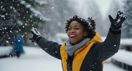 Poster - Cheerful Black female throwing snow in air during winter vacation background