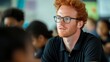 © Tatiana - A man with glasses and red hair is talking to a group of children