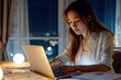 © Sumet - A woman working late at her desk