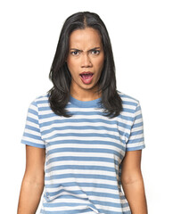 Wall Mural - young latina posing in studio shouting very angry, rage concept, frustrated.