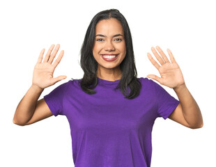 Wall Mural - young latina posing in studio showing number ten with hands.