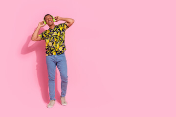 Wall Mural - Full length photo of handsome young guy headphones listen music dressed stylish tropical print garment isolated on pink color background