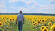 © chusnul - A person walks through a vibrant sunflower field under a bright sky, embodying tranquility and connection with nature.