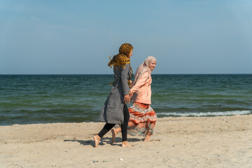 Muslims on the beach, mother with daughter, hijab, girls in hijab lesbians, rest of Muslims at sea, travel, Muslims having fun on the beach, same-sex love, lesbians,