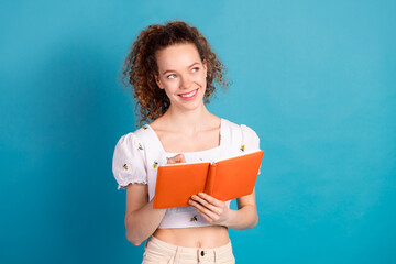 Poster - Photo portrait of attractive young woman write notebook look empty space dressed stylish white clothes isolated on blue color background