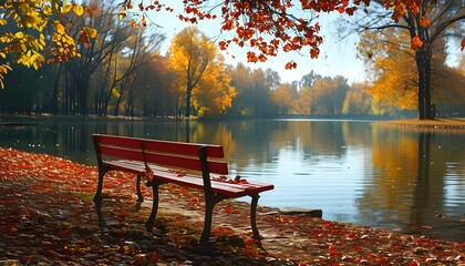 Serene autumn landscape featuring a red bench by a lake reflecting vibrant fall foliage in a sunny park