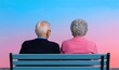 © AucArtStudio - elderly couple sitting on a bench back to back against a colorful sunset sky.