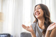 © Art_Photo - Excited asian woman expressing joy at home, cheerful and happy facial expression, positive emotions, surprised female reaction, happiness and delight, lifestyle, young woman celebrating good news