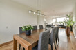 © ADDICTIVE STOCK - Modern dining to living room transition in a home