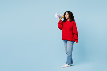 Wall Mural - Full body little kid teen girl of African American ethnicity wear red sweatshirt hold in hand megaphone scream announces discounts sale Hurry up isolated on plain blue background. Childhood concept.