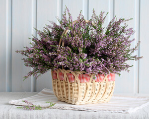 still life with a bouquet of heather on the table in the cottage. summer time, forest heather, a lush bouquet of flowering branches.