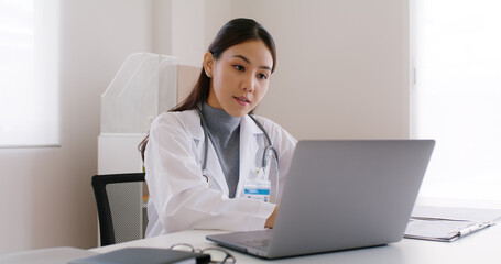 Wall Mural - Young asia people female medic live talk speak look at laptop computer work in online visit clinic care to help see patient on digital telehealth telemedicine smart covid teleconsult VoIP service app.