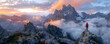 © ADDICTIVE STOCK - Hiker overlooking a majestic mountain range at sunrise